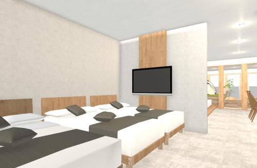 a bedroom with two beds and a flat screen tv at Relax Hotel Takayama Station in Takayama