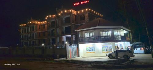 a car parked in front of a building at night at kuza Suites Mbale in Mbale