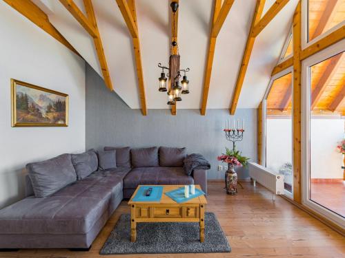 a living room with a couch and a table at gemütliche Ferienwohnung in Cattenstedt in Cattenstedt