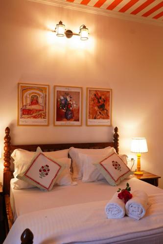 a bedroom with a bed with two towels on it at Aurora Luxe Residence in Jaipur