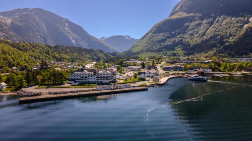 an aerial view of a town on a river with mountains at Vøringfoss Hotel in Eidfjord