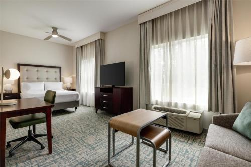 a hotel room with a bed and a desk at Homewood Suites by Hilton Denver West - Lakewood in Lakewood