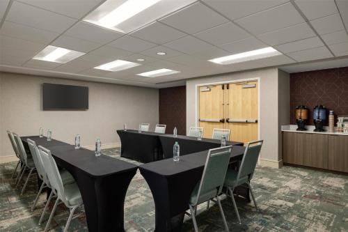 a conference room with a long table and chairs at Homewood Suites by Hilton Denver West - Lakewood in Lakewood