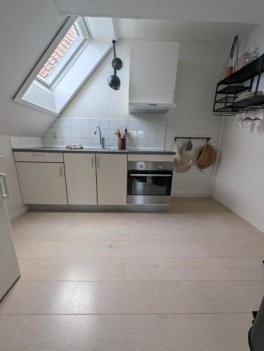 a kitchen with a sink and a stove at Villa Koch X Pension Koch in Gudhjem