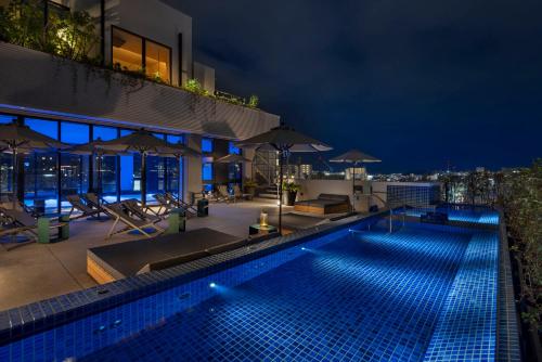 a swimming pool on top of a building at night at Southwest Grand Hotel in Naha