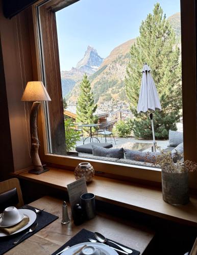 a window with a view of a mountain view at Alpenlodge in Zermatt
