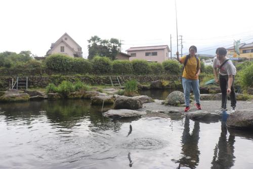 two people are standing on rocks near a pond at Numazu Sparkle in Numazu