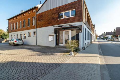 a brick building with a car parked in front of it at 140 qm großes Loft mit 2 eigenen Schlafzimmern im Fabrikstil - direkt in Groß-Umstadt - 300 m bis zum Marktplatz in Groß-Umstadt