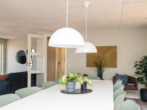 a dining room with a white table and chairs at Luxury Retreat with Pool - By Traum Ferienwohnungen in Ho