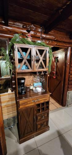 a wooden cabinet with wooden doors in a room at Cabaña English Evergreen in Jardín