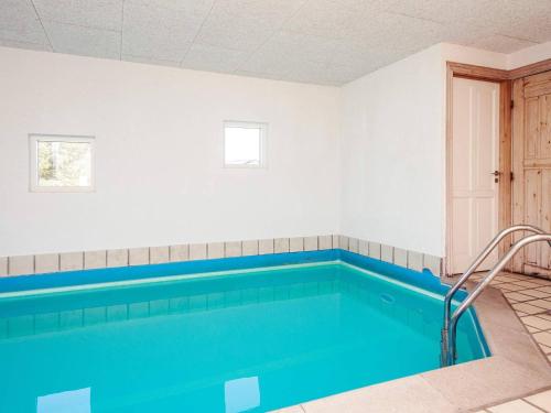 a swimming pool with blue water in a room at Luxury Retreat with Pool - By Traum Ferienwohnungen in Ho
