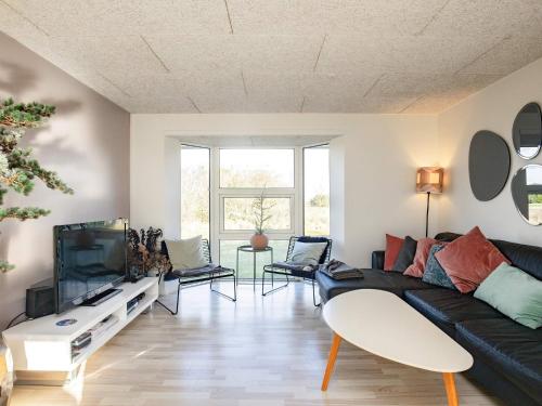 a living room with a black couch and a tv at Luxury Retreat with Pool - By Traum Ferienwohnungen in Ho