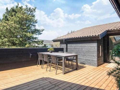 a patio with a table and chairs on a deck at Luxury Retreat with Pool - By Traum Ferienwohnungen in Ho