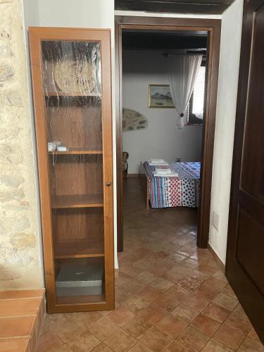 a room with a door open to a room with a bedroom at La Casa di Mariannina in Monasterace