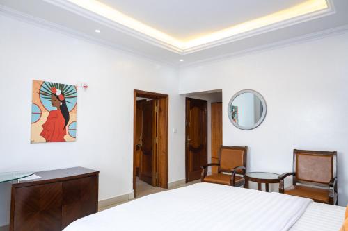 Postel nebo postele na pokoji v ubytování OMX Hotel Kimihurura
