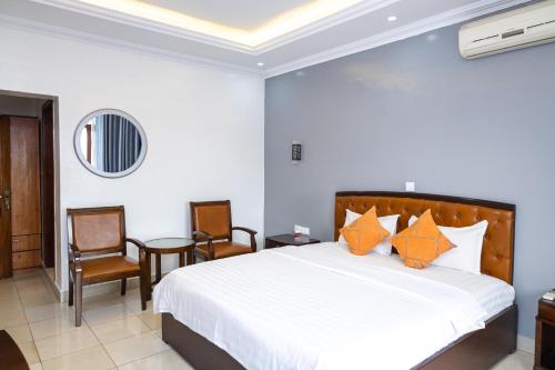 Postel nebo postele na pokoji v ubytování OMX Hotel Kimihurura