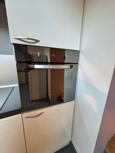 a small kitchen with a stove top oven in a room at Le gite de Francesco in Chemaudin