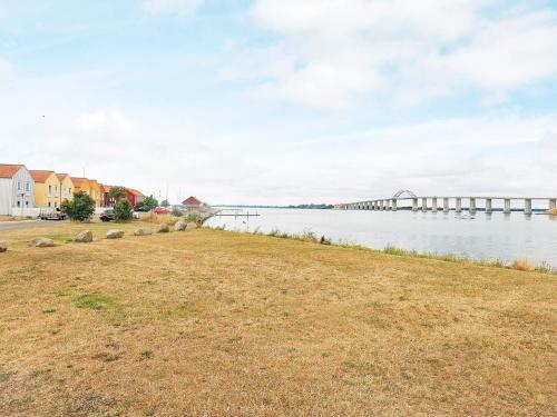 a large body of water with a bridge in the background at 6 person holiday home in Rudkøbing-By Traum in Rudkøbing
