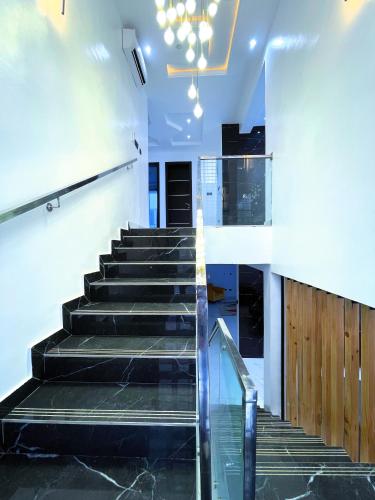 a staircase in a building with a glass floor at Ifemide Estates - Luxury Homes in Akure