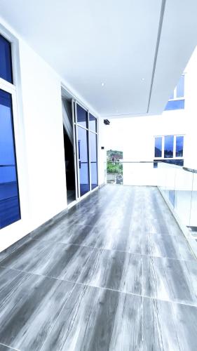 an empty room with a wooden floor in a building at Ifemide Estates - Luxury Homes in Akure