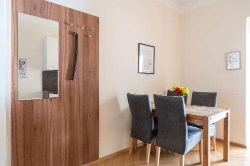 a dining room with a wooden table and chairs at Vienna Stay Apartments Schönbrunn in Vienna