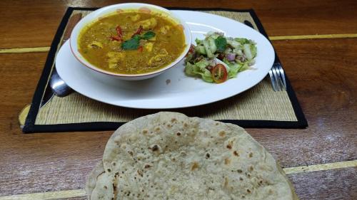 a plate of food with a bowl of soup and a tortilla at Le Soleil Kep - Surya Kep in Kep