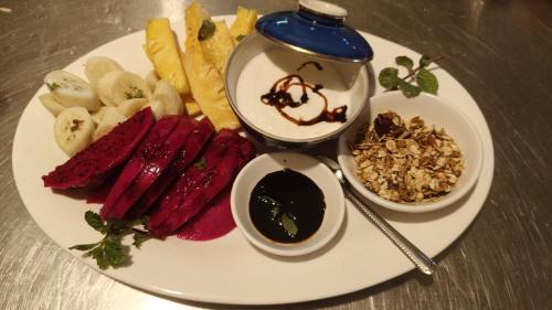 a plate of food on a table with food on it at Le Soleil Kep - Surya Kep in Kep