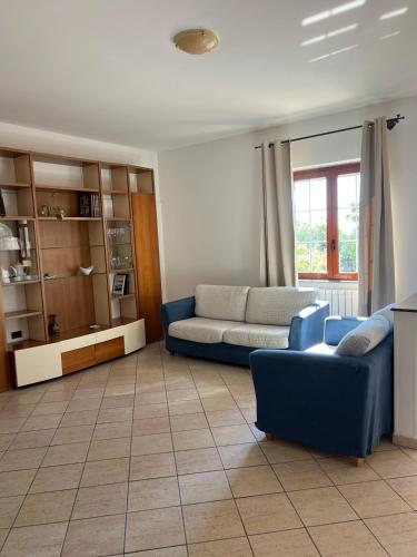 a living room with a blue couch and a table at La Maison di Franca in Riace Marina