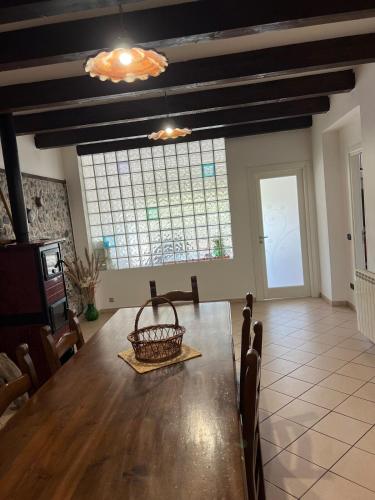 a dining room with a table and a large window at La Maison di Franca in Riace Marina