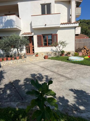 a house with a driveway in front of it at La Maison di Franca in Riace Marina