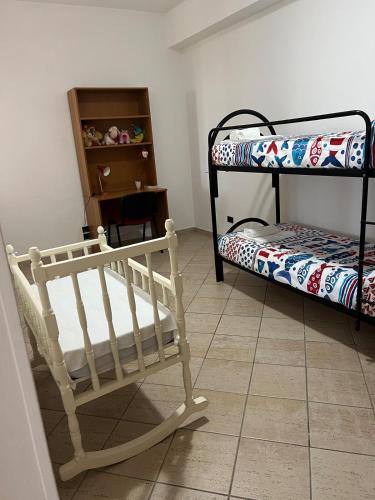 a room with two bunk beds and a chair at La Maison di Franca in Riace Marina