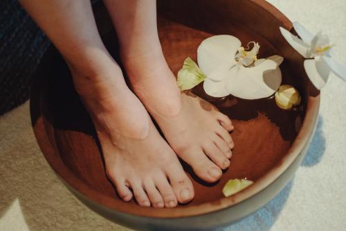 a person with their feet in a bowl of cake at Southwest Grand Hotel in Naha