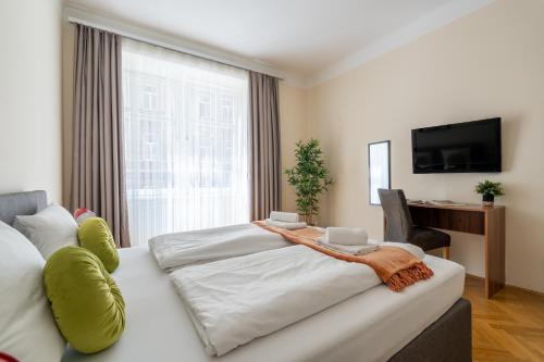 a bedroom with two beds and a large window at Vienna Stay Apartments Schönbrunn in Vienna