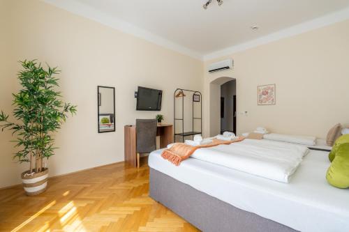 a bedroom with a bed and a potted plant at Vienna Stay Apartments Schönbrunn in Vienna