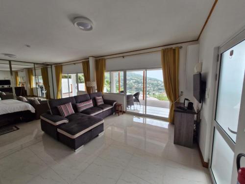 a living room with a couch and a bed at Bel Air Holiday Apartments in Victoria