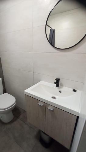 a bathroom with a white sink and a mirror at Gästewohnung Sommer Locktow, Hauptstraße 1 in Locktow