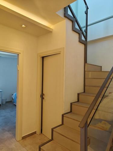 a staircase in a house with a glass railing at Migdal Luxury Suites - Sea Dream in Netanya