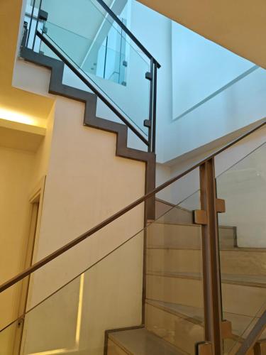 a glass staircase in a house at Migdal Luxury Suites - Sea Dream in Netanya