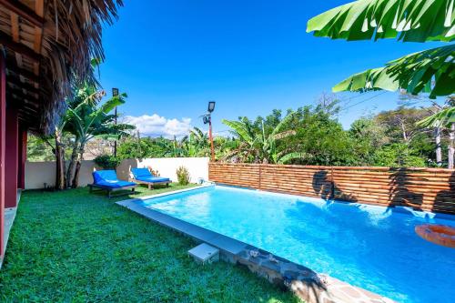 a swimming pool in the backyard of a house at Ambaro Paradise Villa in Ambaro