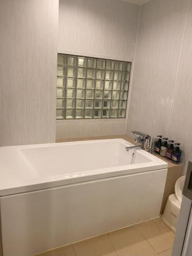 a white bath tub in a bathroom with a window at Carnet (Adult Only) in Amagasaki