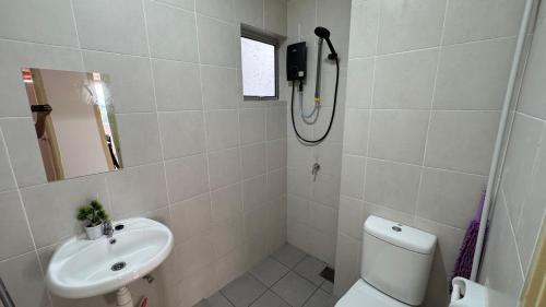 a bathroom with a toilet and a sink at Kondominium Timur Perdana, Near UTAR, Bandar Baru, Kampar Perak in Kampar