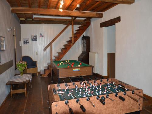 a room with a pool table and a staircase at Holiday Home in Rendeux with Terrace in Rendeux