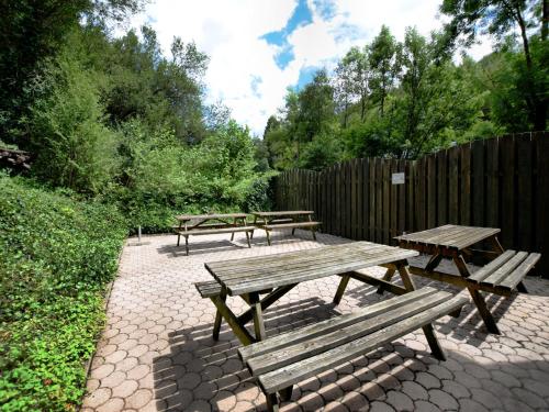 a group of picnic tables and a fence at Holiday Home in Rendeux with Terrace in Rendeux