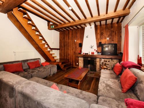 a living room with a couch and a fireplace at Holiday Home in Rendeux with Terrace in Rendeux