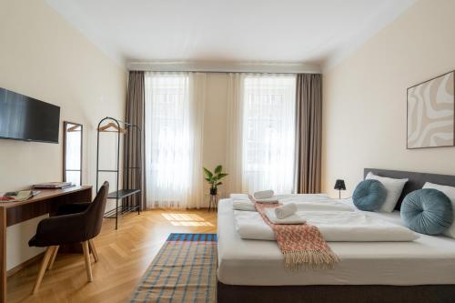 a bedroom with a large bed and a desk at Vienna Stay Apartments Schönbrunn in Vienna