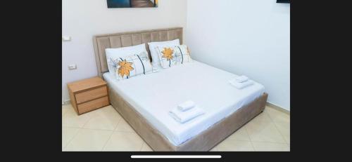 a bedroom with a bed with two pillows on it at Brusiano in Vlorë