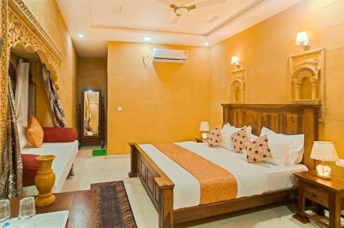 a bedroom with a large bed and a couch at Taj Luxurious Resort - Desert Camping Tents Jaisalmer in Jaisalmer