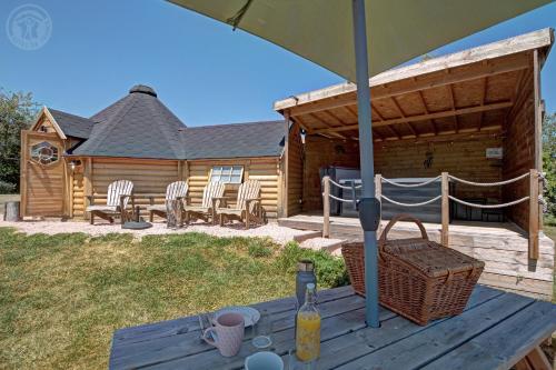 a picnic table in front of a log cabin at Les Cabanes du Grand Nord in Pradines
