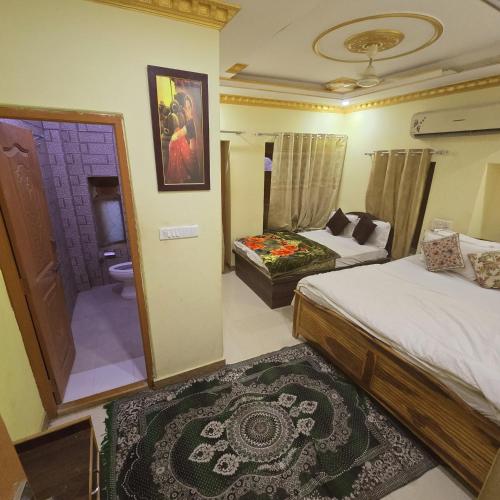a hotel room with two beds and a bathroom at Taj Luxurious Resort - Desert Camping Tents Jaisalmer in Jaisalmer