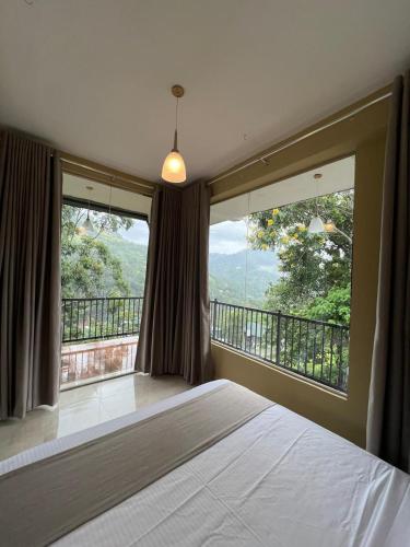 a bedroom with a bed and a large window at Ella Family House in Ella